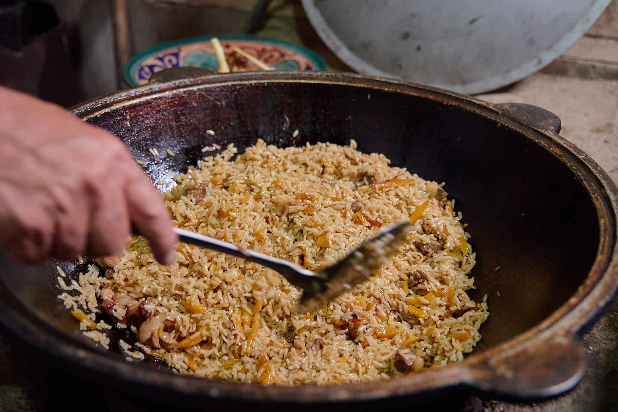 Cooking plov in a kazan in Fergana Valley, Uzbekistan